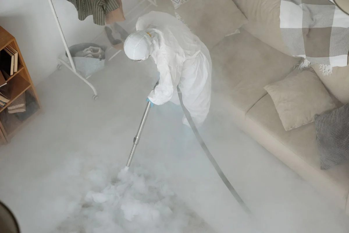 Biohazard cleanup technician in protective equipment, Lake Mills, IA